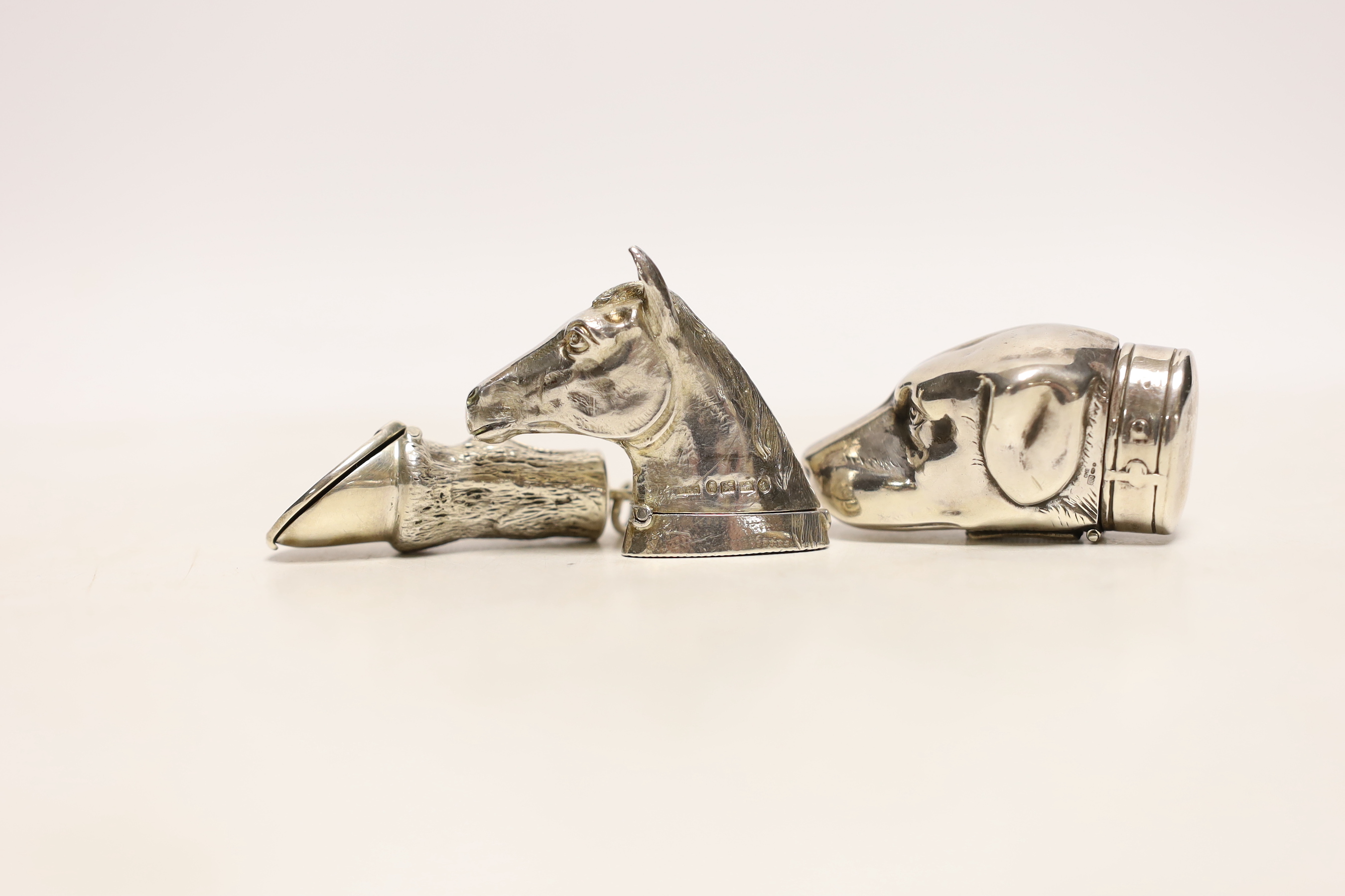 A Victorian novelty silver vesta case, modelled as a horse's head, HBs, Birmingham, 1884, 41mm, together with two modern vesta cases modelled as a horse's hoof and dog's head.